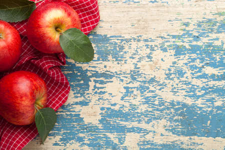 Gala red apple. Fresh fruits and green leaves on wooden table. Copy space. Top viewの写真素材