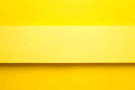 Yellow paper banner on yellow paper background. Top view. Copy space. Flat lay