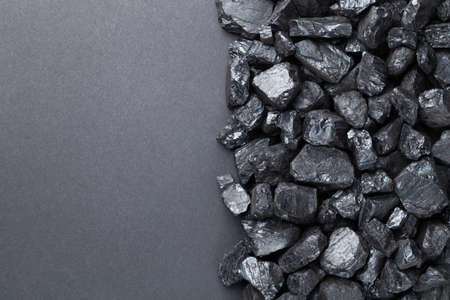 Natural coal heap on black background. Copy space. Top viewの写真素材