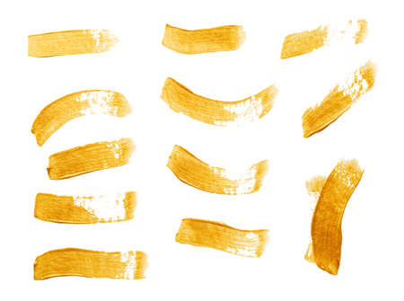 Set of golden paint strokes isolated on white backgroundの写真素材