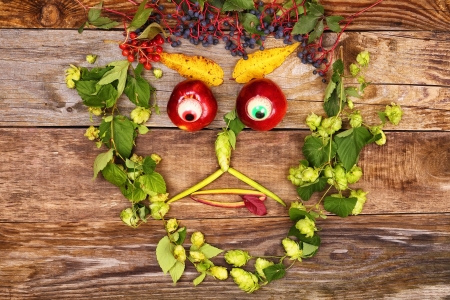 Funny happy face out of various fruits and plants, looks downの写真素材