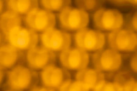 Abstract blurred light bokeh orange colored as backgroundの写真素材