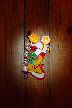 Christmas sock with candies on the wooden background, close upの写真素材