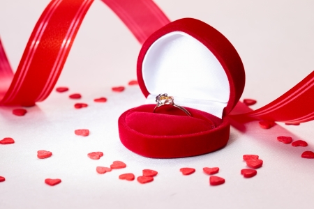 Heart shaped gift box with ring and valentine day decorationsの写真素材