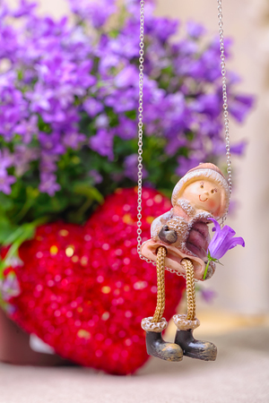 Valentine greeting card with flowers, heart and romantic boy figurineの写真素材