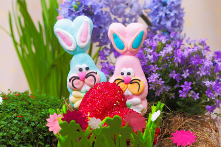 Pair of easter candy bunnies with heart in nest
