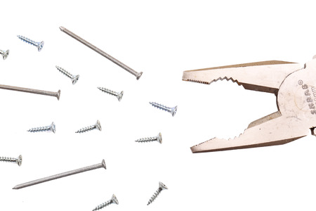 Pliers, screws and nails, represent predator and victims, isolated on whiteの写真素材