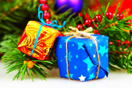 Little christmas gift boxes with branch of fir and decorations, selective focus
