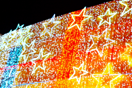 Christmas illumination on facade of modern building, blurred image as backgroundの写真素材