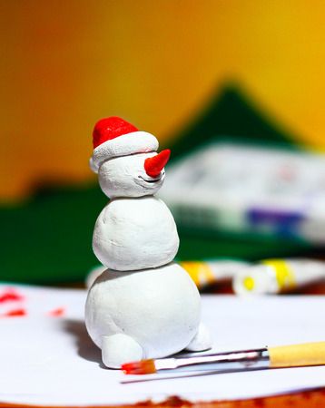 Cute snowman handmade figurine in process of making ofの写真素材