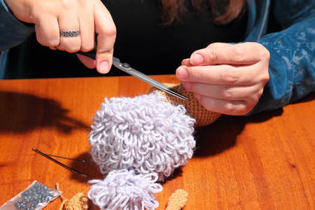 Process of making of knitted sheep toy, close upの写真素材