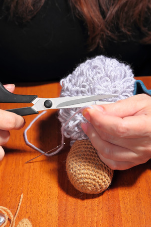 Process of making of knitted sheep toy, close upの写真素材