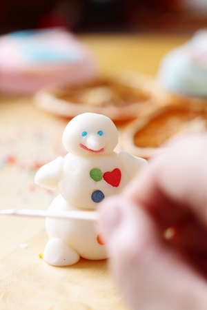 Making snowman from sugar mastic. Make smile.の写真素材