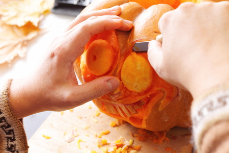 Process of carving out a pumpkin to prepare halloween lanternの写真素材