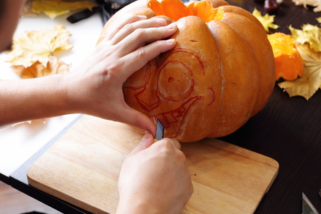 Process of carving out a pumpkin to prepare halloween lanternの写真素材