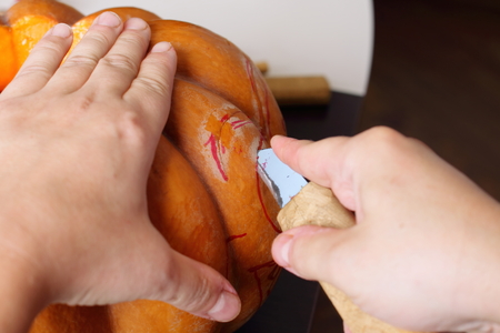 Process of carving out a pumpkin to prepare halloween lanternの写真素材