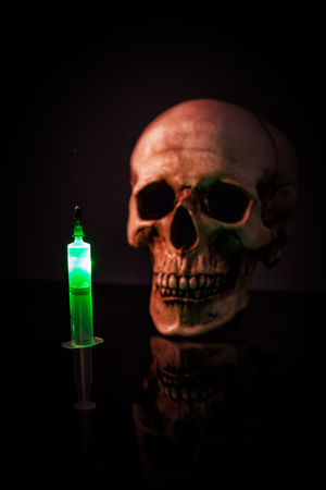 Syringe over human skullの写真素材