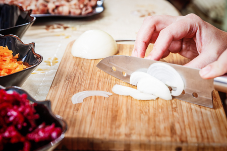 preparing russian traditional salad herring under fur coatの写真素材