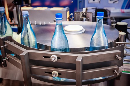 Empty glass bottles on the conveyor. Demonstration of working