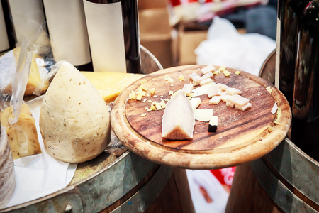 cheese plate - various types of cheese on a wooden cutting boardの写真素材