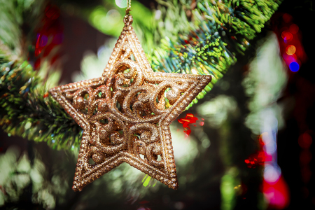 Decorative golden star on the christmas treeの写真素材