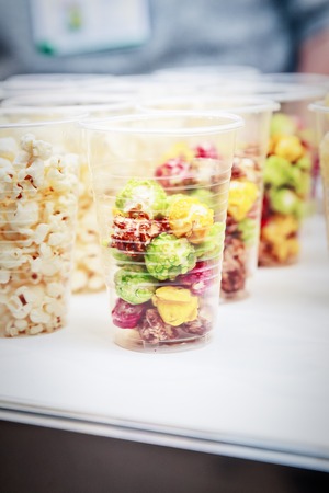 Colorful popcorn in the plastic cups, close up view