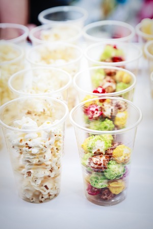 Colorful popcorn in the plastic cups, close up viewの写真素材