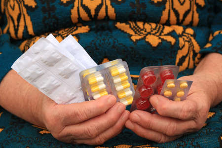 Medicines in hands of the elderly womanの写真素材