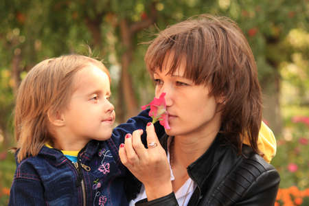 Mum and the daughter having a rest on the natureの写真素材