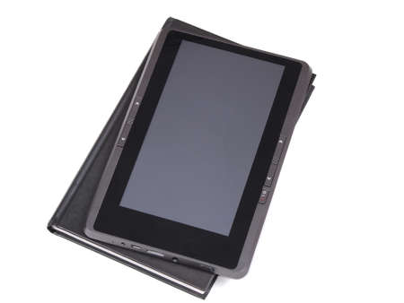 The electronic book lying on the paper book        