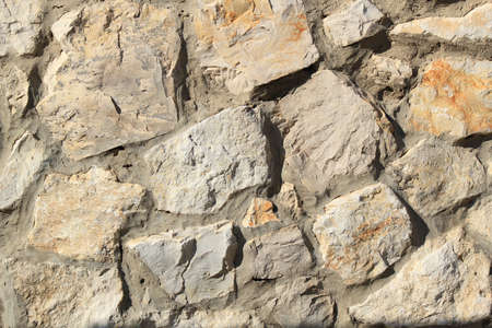 Fragment of rough stone facing of the houseの写真素材