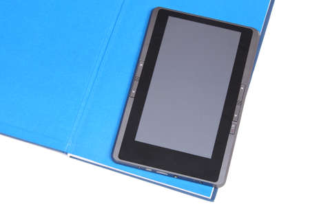 The electronic book lying on the opened paper blue bookの写真素材