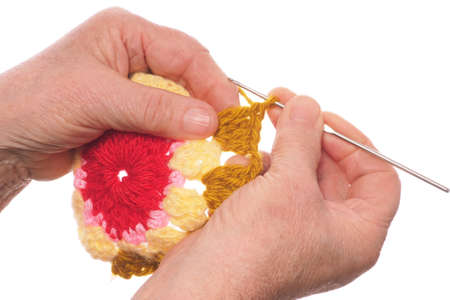 Hands of the elderly woman knitting by means of the hookの写真素材