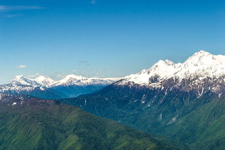 Mountain valley with snow-capped mountain peaks. height 2320 above sea level Esto-Sadok Russia Sochi