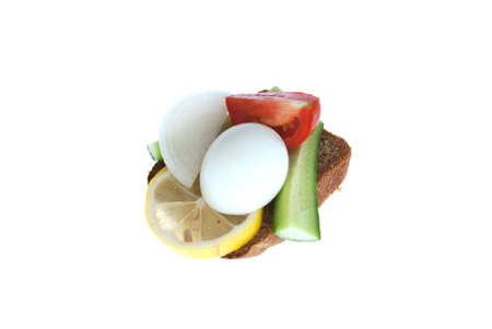 Rye-bread with boiled egg, lemon and vegetables. Isolated on white background.