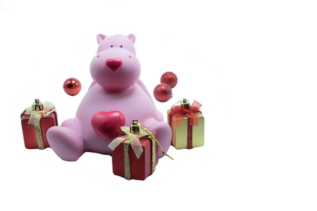 Pink hippopotamus doll among red and gold color of gift box for decorationCute pink hippopotamusの写真素材
