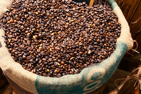 Coffee bean in coffee sack with oak barrel and wooden wall Coffee bean in coffee sackの写真素材