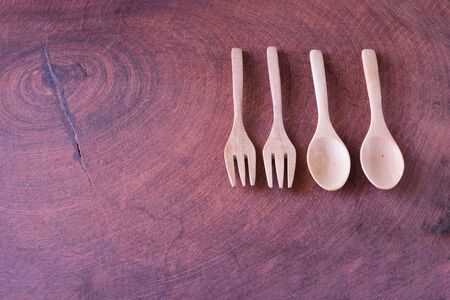 Two pair of wooden spoon and fork on wooden table on the sunny day Two pair of wooden spoon and forkの写真素材