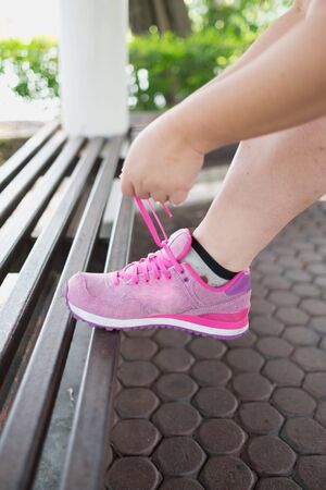Woman tie pink sneaker get ready to run and exercise for healthy Tie your sneaker and runの写真素材