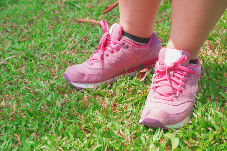 Pink sneaker on the grass in the parkの写真素材