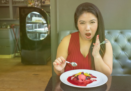 woman with exciting and surprising face want to eat fresh strawberry blueberry raspberry crape/woman and all berry crapeの写真素材