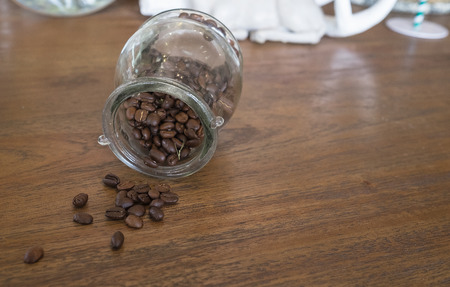 coffee bean on coffee table in coffee glass jar in coffee shopの写真素材