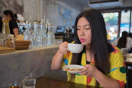 woman and hot coffee woman and hot tea woman blowing coffee woman cooling coffee down woman making...