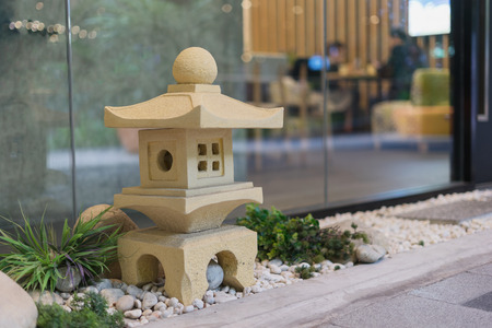 small yellow japanese stone pavilion on the floor as a garden decorationの写真素材