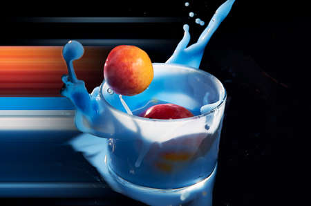 Apricot falling into a glass of blue smoothie