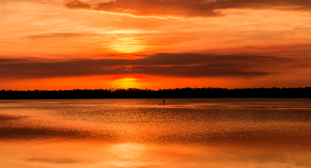 Relaxing Sunset with Paddleboarderの写真素材