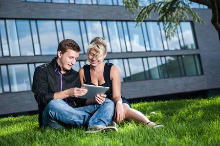 two business people discussing a project on Tablet Computers