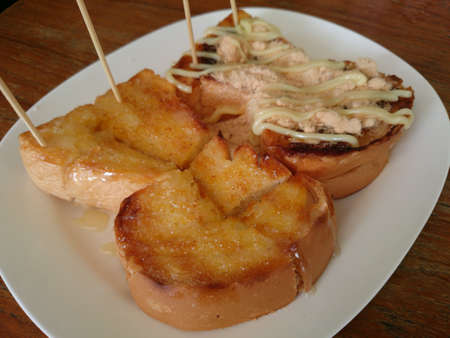 Toast a slice of bread 2 sheets topped with butter, milk, sugar, dried shredded pork and chili pasteの素材