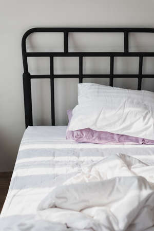 In the morning, The light from the window, lean on the white bed.の写真素材