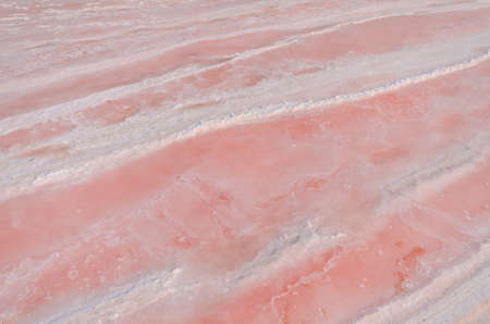 Sea water is evaporated, it begin to crystallize and change color is pink. Nature Background.の写真素材